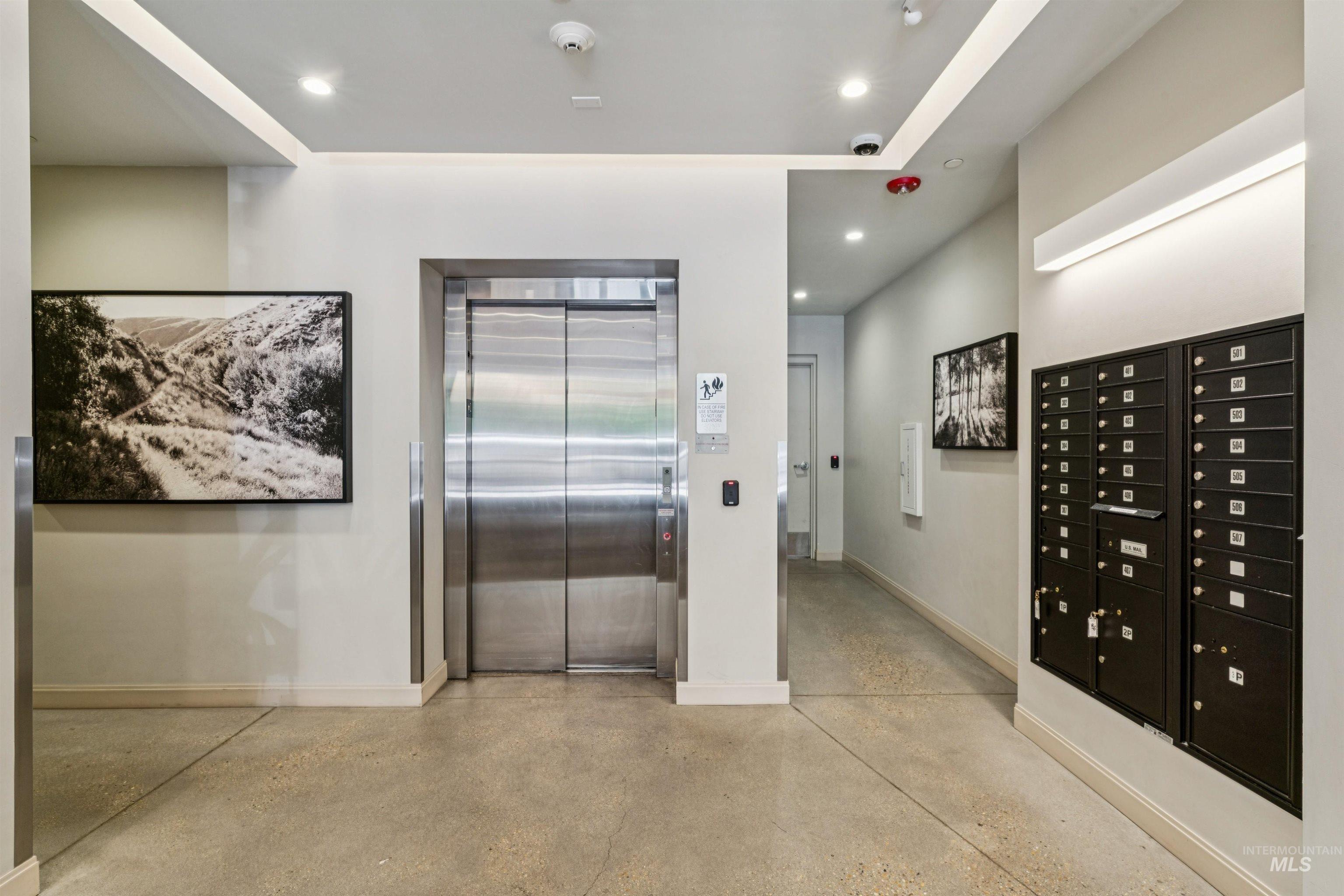 119 South 10th Street, Unit 307 Boise, ID 83702 - Photo 37 of 47 Elevator lobby featuring a stainless steel elevator, concrete flooring, integrated lighting, and mounted mailboxes