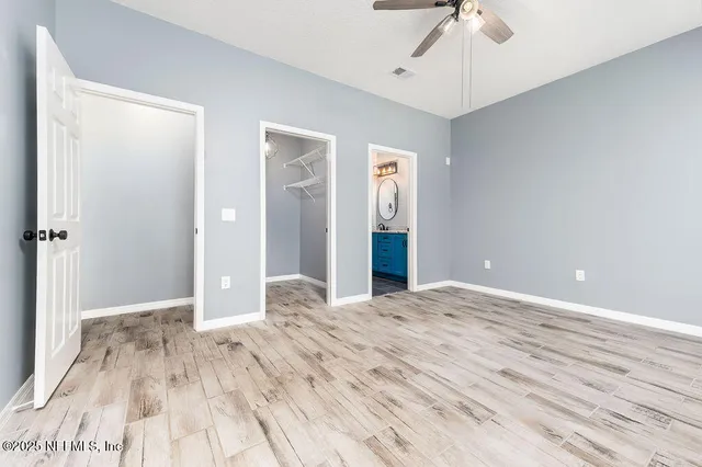 a view of empty room with wooden floor