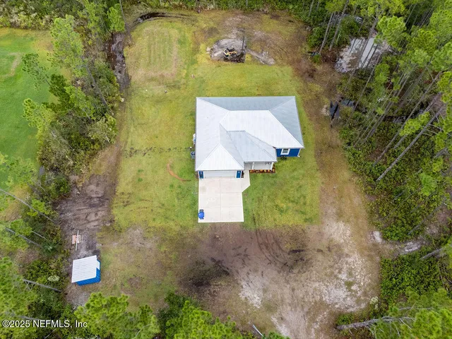 an aerial view of residential house with outdoor space