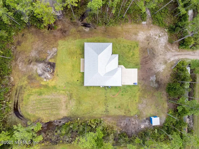 an aerial view of residential house with outdoor space
