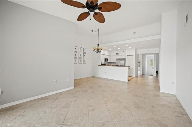 a view of a kitchen with a sink and a chandelier fan