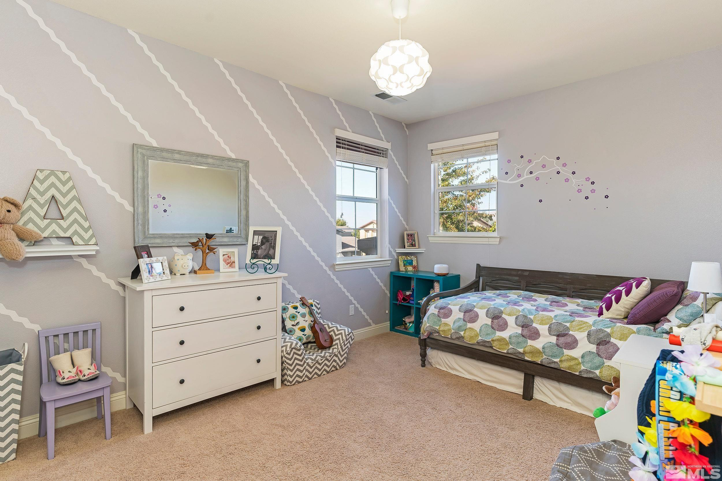 650 Equine Court Reno, NV 89521 - Photo 19 of 27 a bedroom with a bed and a chandelier