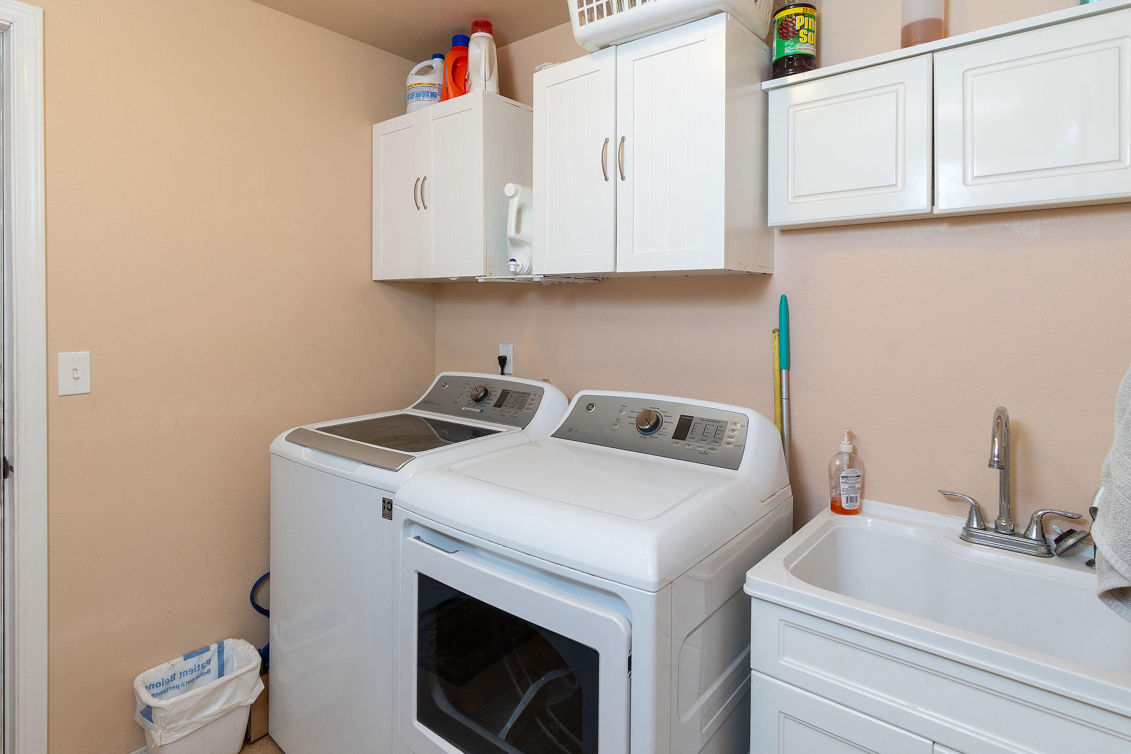411 Northwest Mc Donald Road Prineville, OR 97754 - Photo 17 of 47 Laundry room with utility sink and cabinets.
