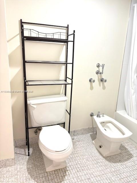 210 174th Street, Unit 818 Sunny Isles Beach, FL 33160 - Photo 13 of 25 a white toilet sitting next to a bathroom sink and a mirror