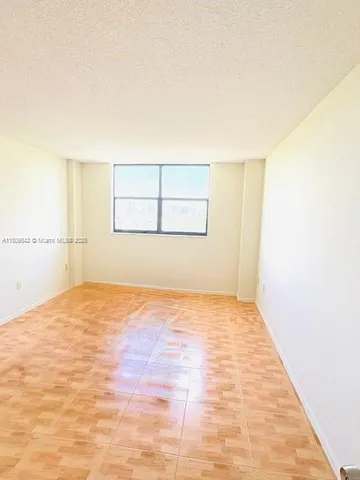 an empty room with a empty space and window