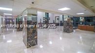 210 174th Street, Unit 818 Sunny Isles Beach, FL 33160 - Photo 20 of 25 a lobby with chandelier and livingroom with furniture