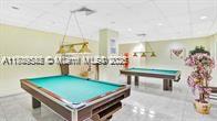 210 174th Street, Unit 818 Sunny Isles Beach, FL 33160 - Photo 22 of 25 a room with pool table table and chairs