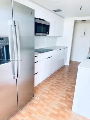 a kitchen with stainless steel appliances a refrigerator and a sink