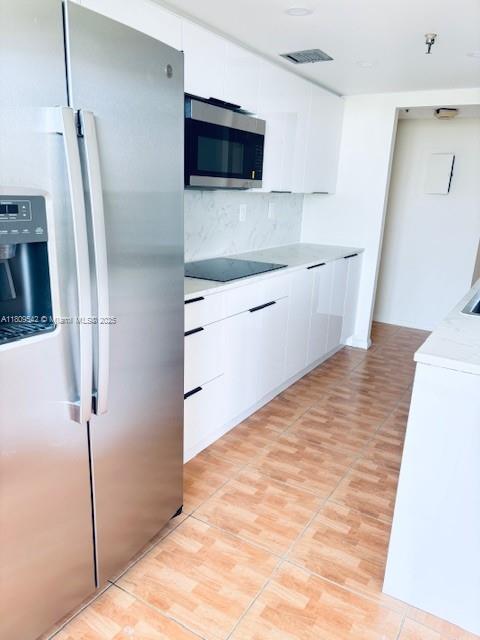 210 174th Street, Unit 818 Sunny Isles Beach, FL 33160 - Photo 6 of 25 a kitchen with stainless steel appliances a refrigerator and a sink