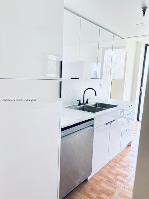 210 174th Street, Unit 818 Sunny Isles Beach, FL 33160 - Photo 7 of 25 a kitchen with a sink and a refrigerator