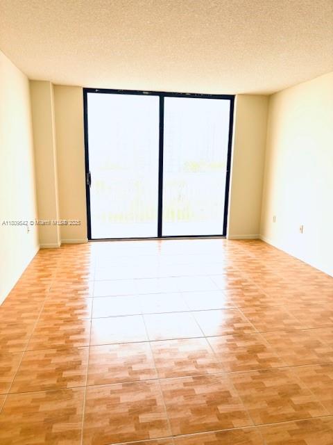 210 174th Street, Unit 818 Sunny Isles Beach, FL 33160 - Photo 9 of 25 a view of empty room with wooden floor