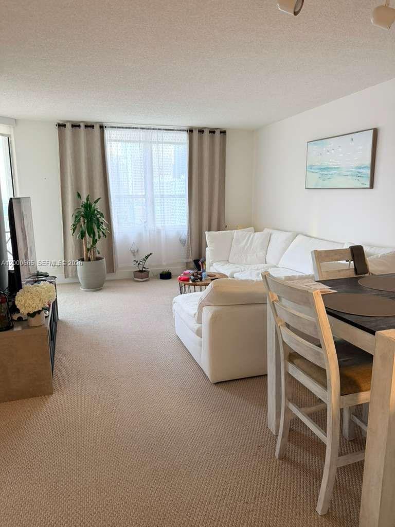 701 Brickell Key Boulevard, Unit 1501 Miami, FL 33131 - Photo 5 of 8 a bedroom with furniture and a window