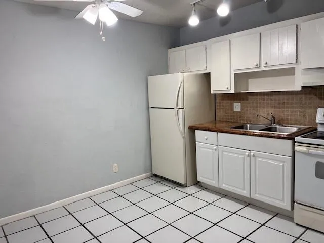 a kitchen with cabinets and stainless steel appliances