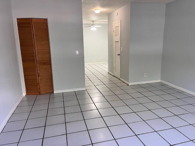 1721 Northwest 15th Vista, Unit 12 Boca Raton, FL 33432 - Photo 6 of 8 an empty room with wooden floor