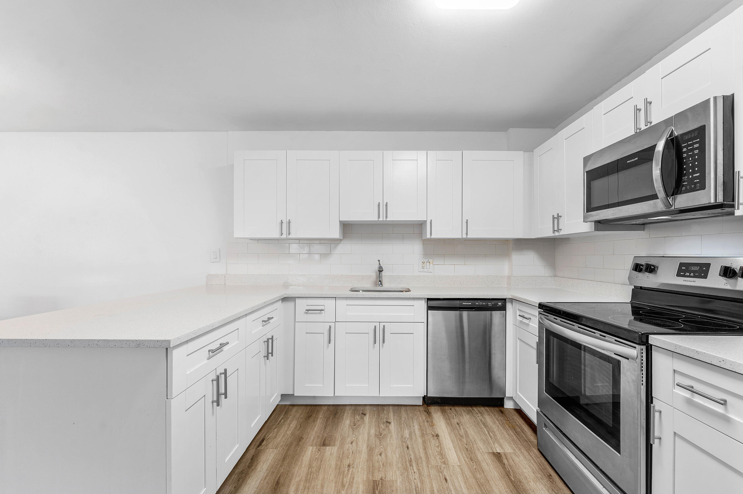 22725 Southwest 66th Avenue, Unit 103 Boca Raton, FL 33428 - Photo 4 of 14 Kitchen – Renovated White Cabinetry