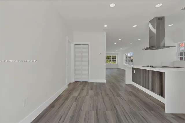 a view of kitchen with wooden floor and electronic appliances
