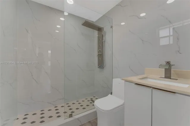 a bathroom with a sink toilet and shower