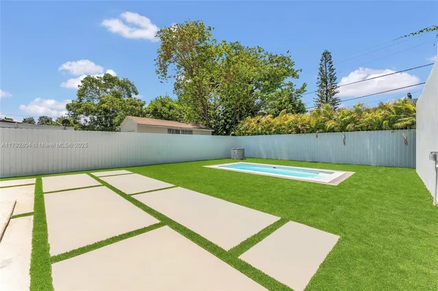 a view of yard with swimming pool