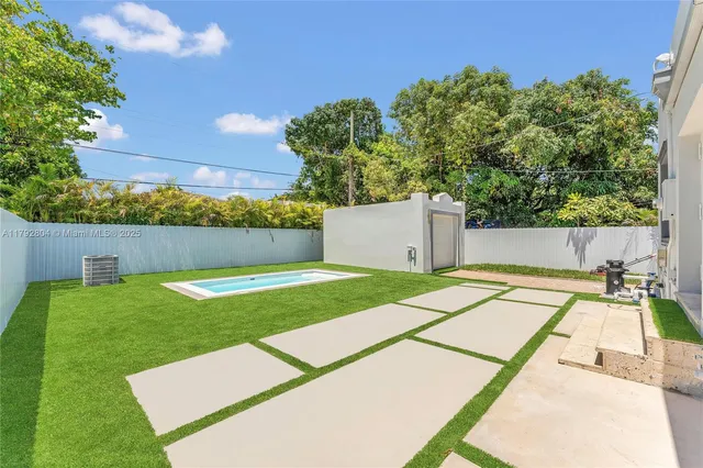 a view of backyard with a white house