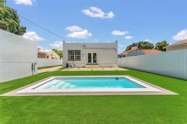 a swimming pool with outdoor seating and yard