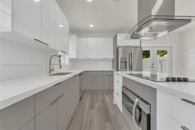 a large white kitchen with a large window
