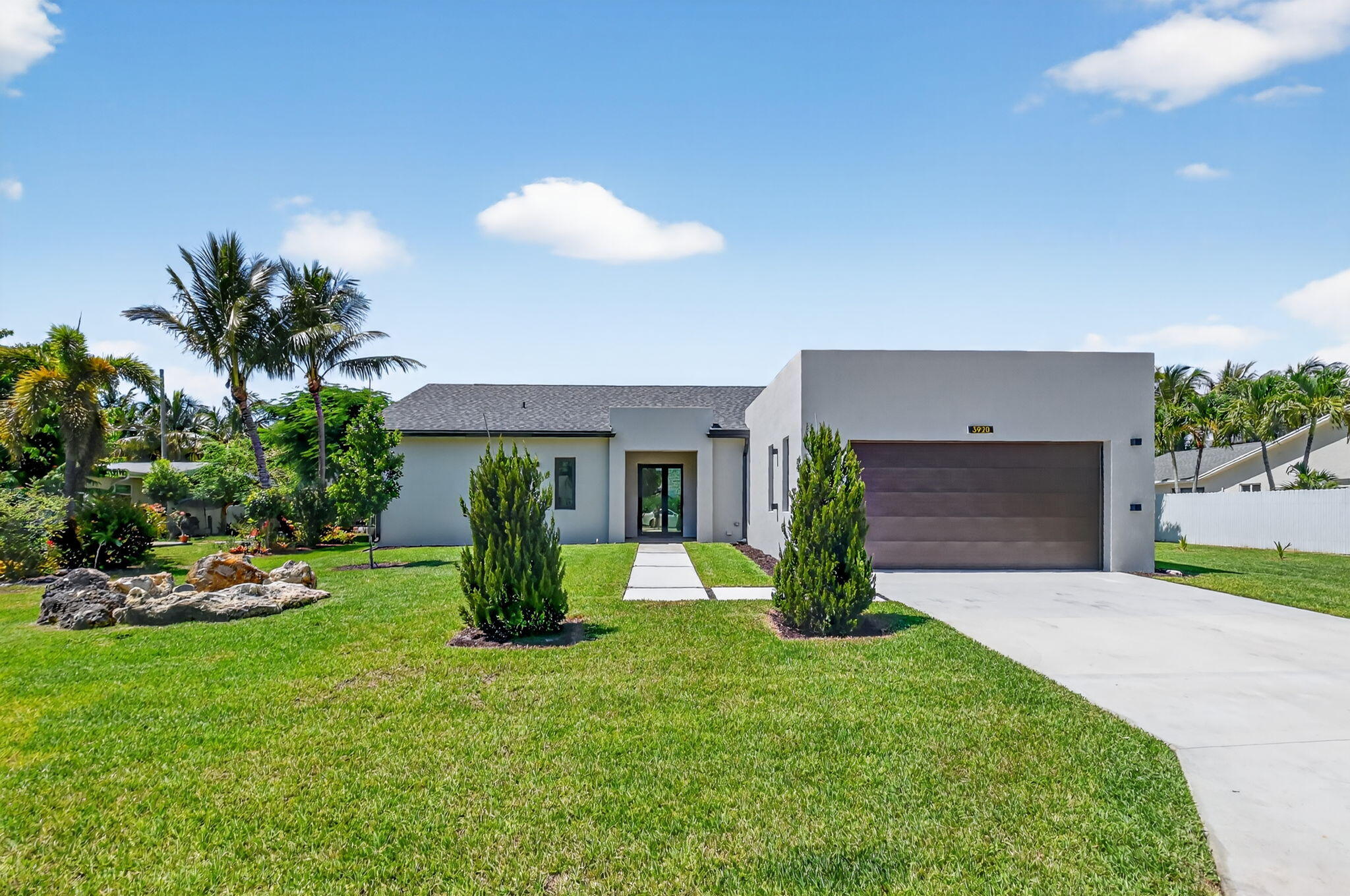 3920 Espan Court Palm Springs, FL 33461 - Photo 1 of 51 a view of a house with backyard and a garden