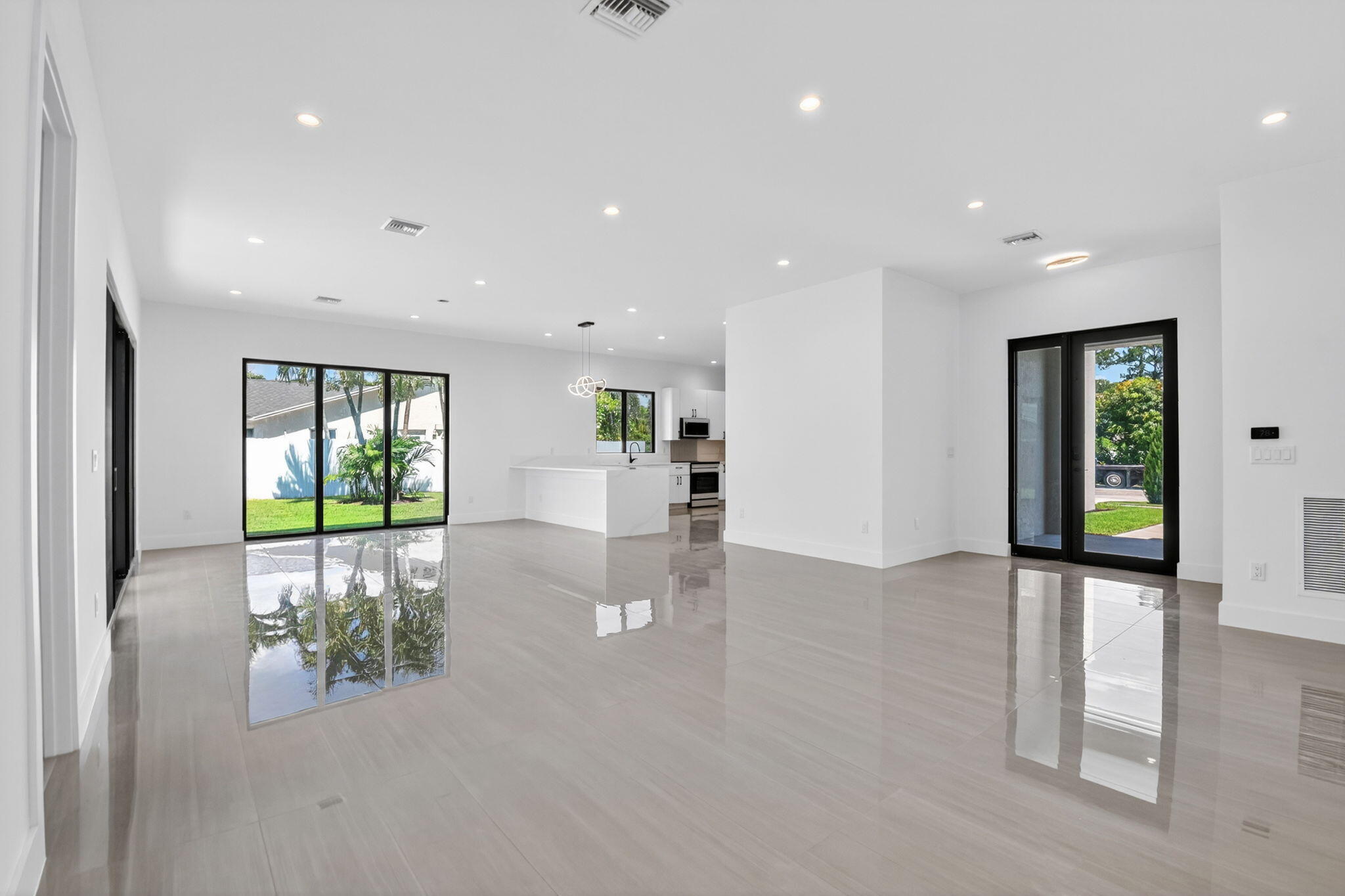 3920 Espan Court Palm Springs, FL 33461 - Photo 12 of 51 a view of an empty room with window and wooden floor