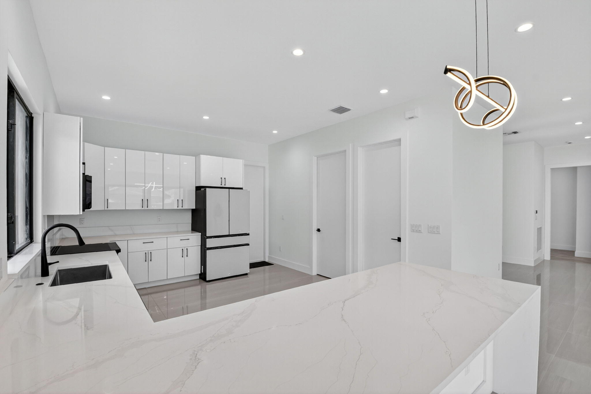 3920 Espan Court Palm Springs, FL 33461 - Photo 19 of 51 a kitchen with granite countertop a sink a stove a refrigerator and cabinets