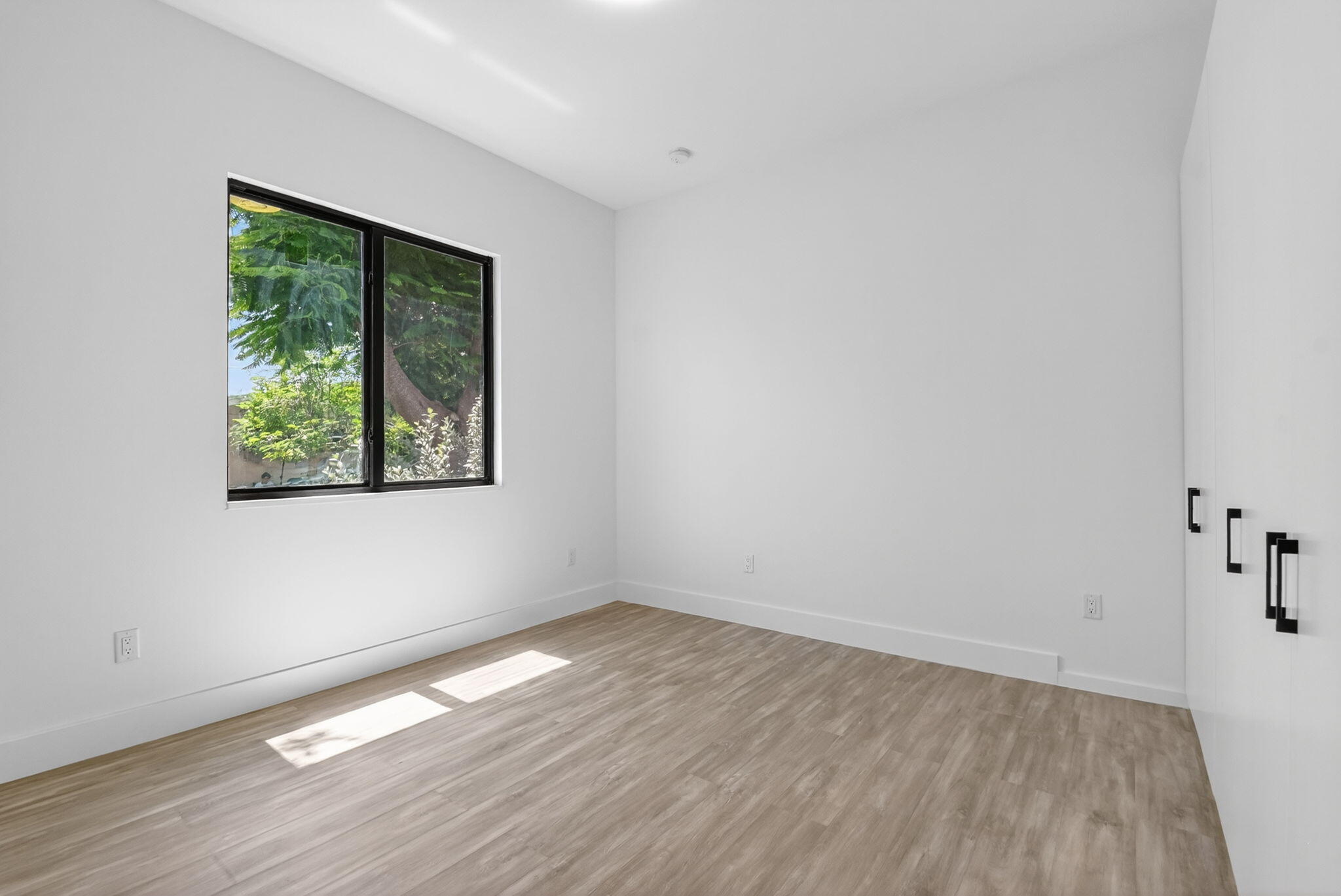 3920 Espan Court Palm Springs, FL 33461 - Photo 34 of 51 an empty room with wooden floor and windows