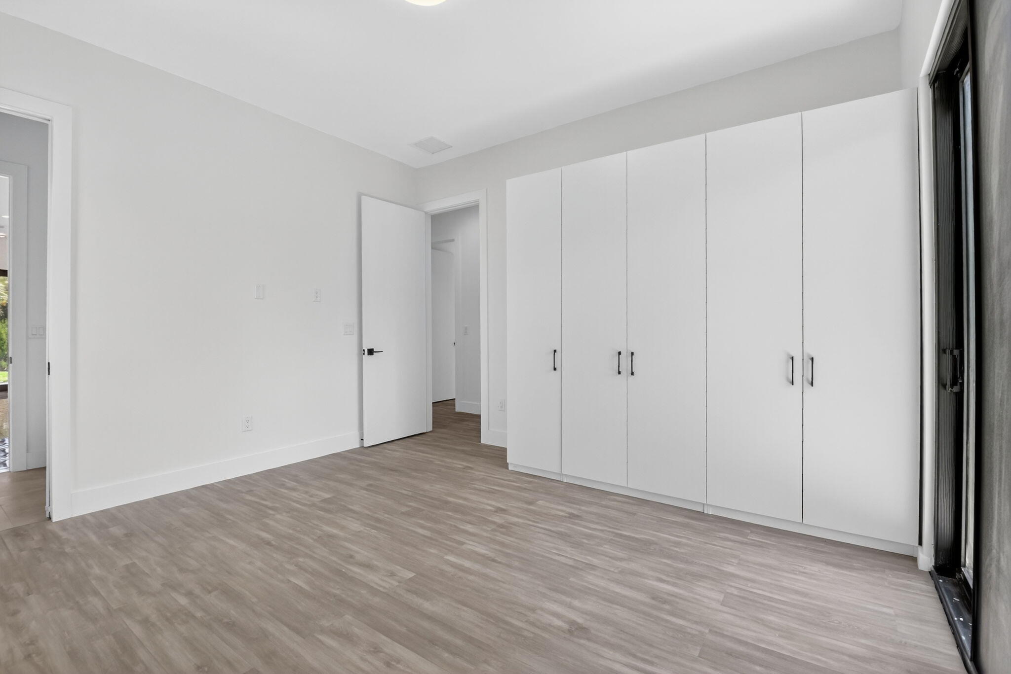 3920 Espan Court Palm Springs, FL 33461 - Photo 40 of 51 a view of an empty room with wooden floor
