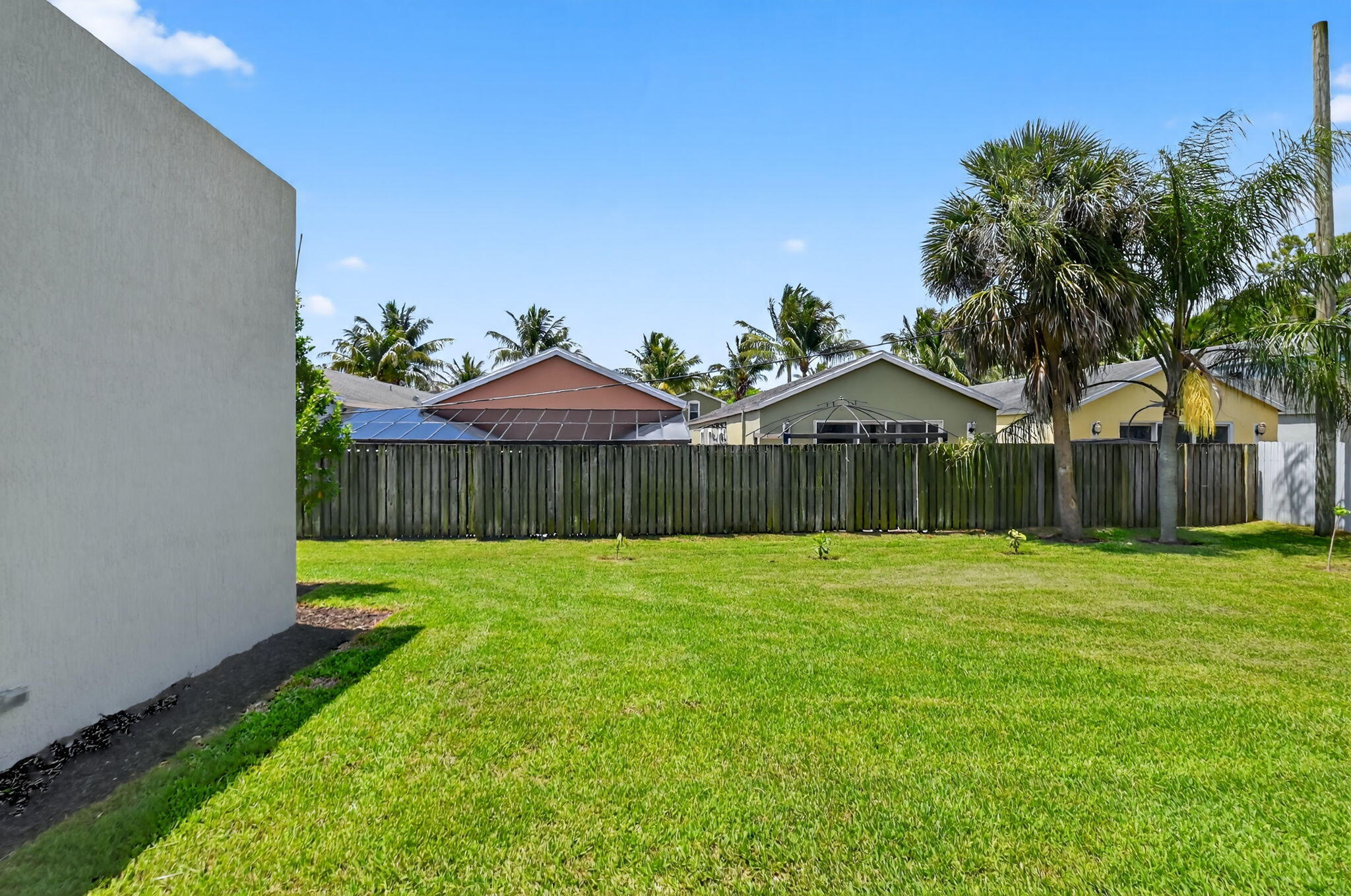 3920 Espan Court Palm Springs, FL 33461 - Photo 43 of 51 a backyard of a house with lots of green space