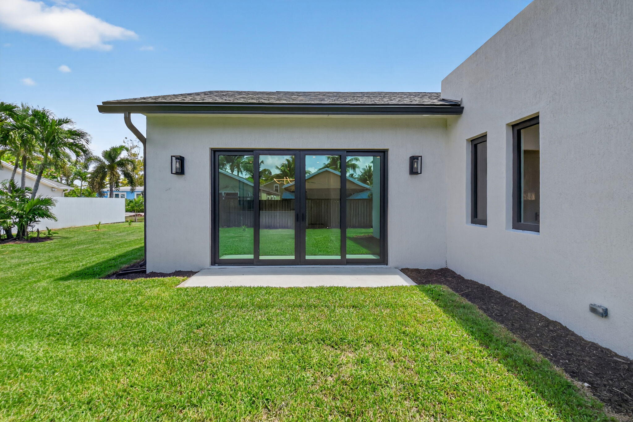 3920 Espan Court Palm Springs, FL 33461 - Photo 51 of 51 a front view of a house with a yard and garage