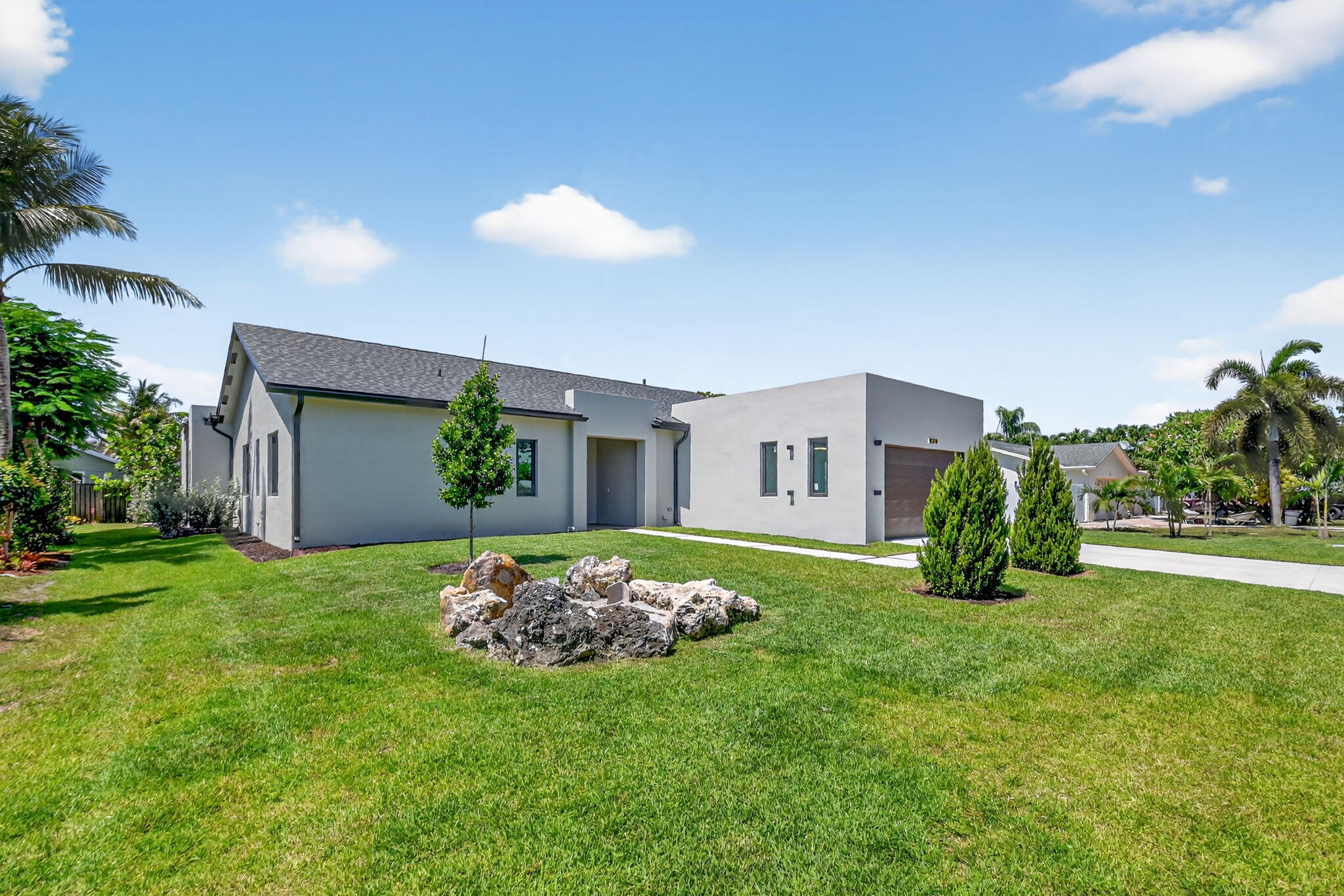 3920 Espan Court Palm Springs, FL 33461 - Photo 6 of 51 a view of a house with a big yard and potted plants