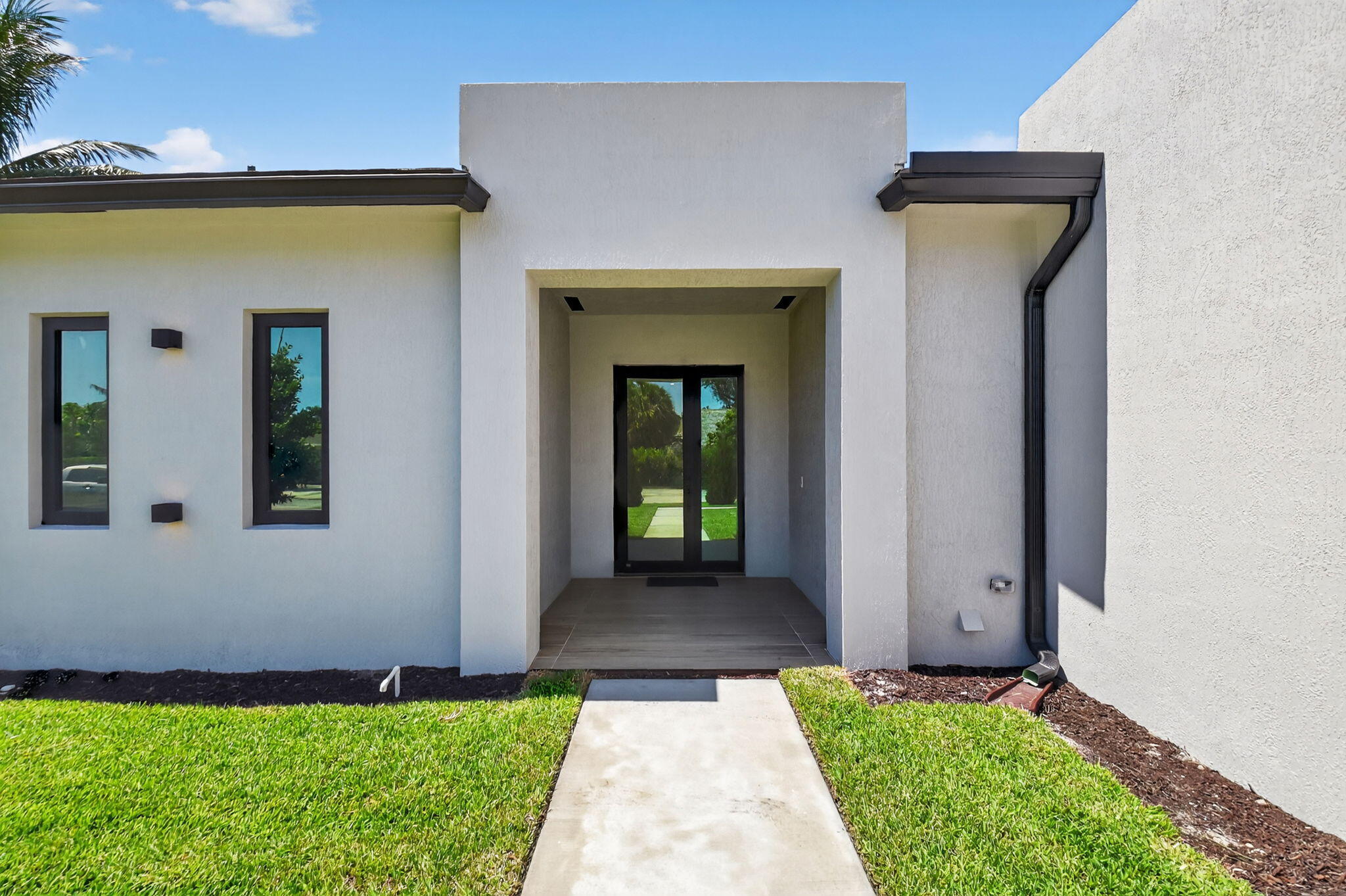 3920 Espan Court Palm Springs, FL 33461 - Photo 8 of 51 a front view of a house with a yard