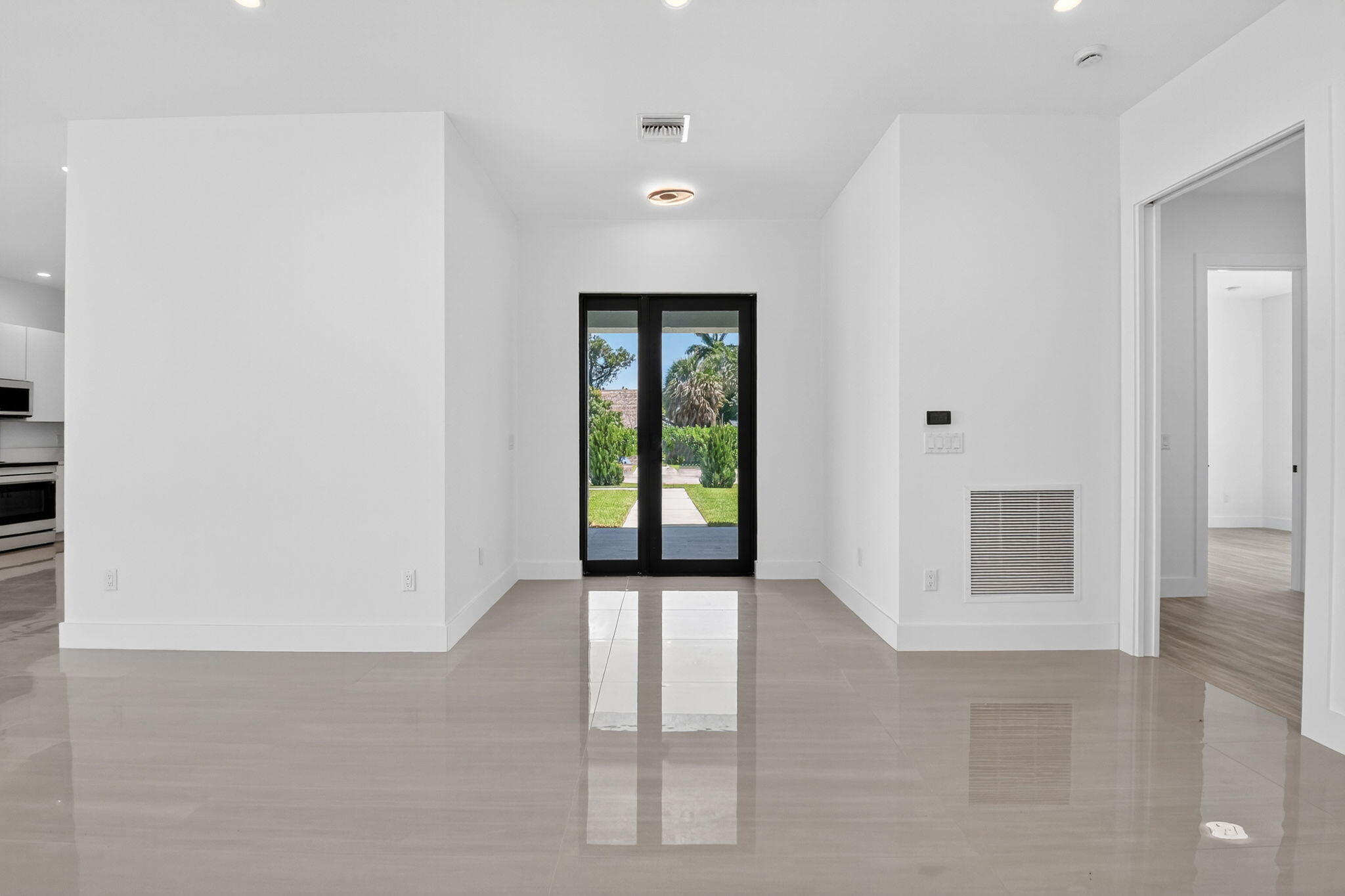 3920 Espan Court Palm Springs, FL 33461 - Photo 10 of 51 an empty room with windows and cabinet