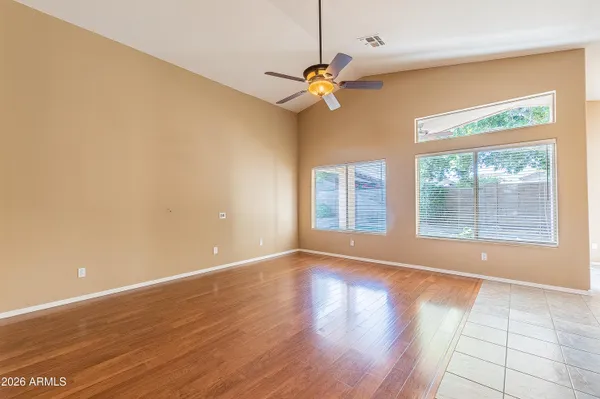 a view of room with window ceiling fan and hardwood floor