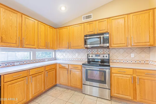 a kitchen with granite countertop cabinets stainless steel appliances and a sink