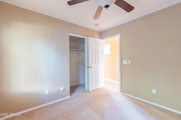 a view of a livingroom with a ceiling fan and window
