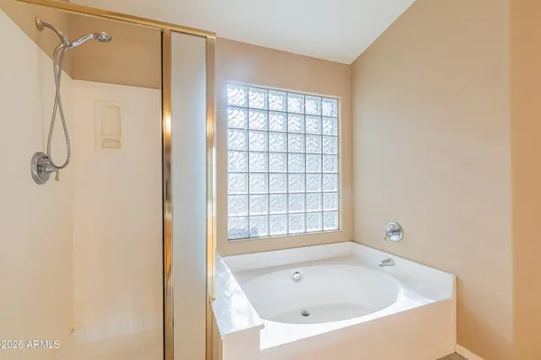 a bathroom with a bathtub and shower