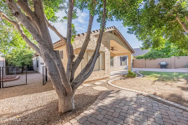 a view of a house with a tree in the background