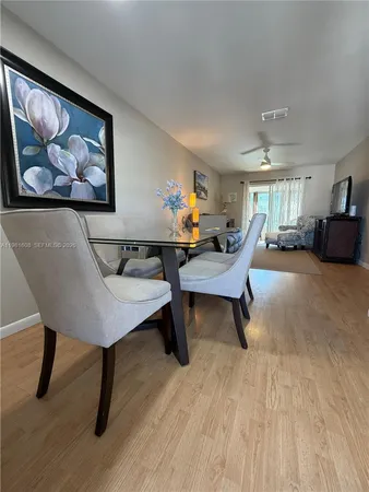 a living room with furniture a rug and a painting on the wall