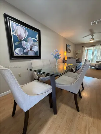 a view of a room with furniture and wooden floor