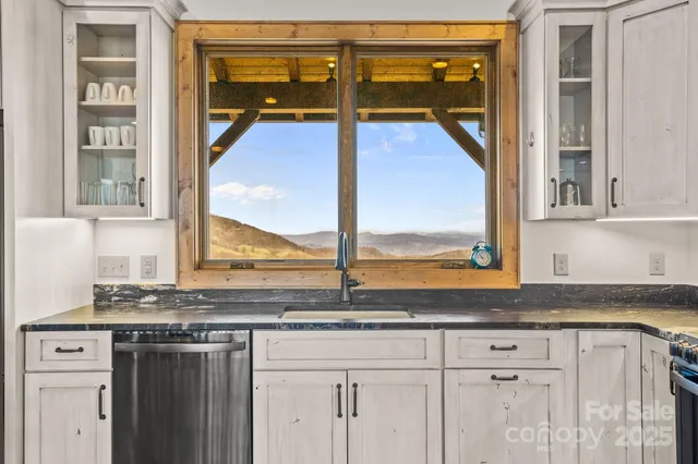 a bathroom with a granite countertop bathtub sink vanity mirror and toilet