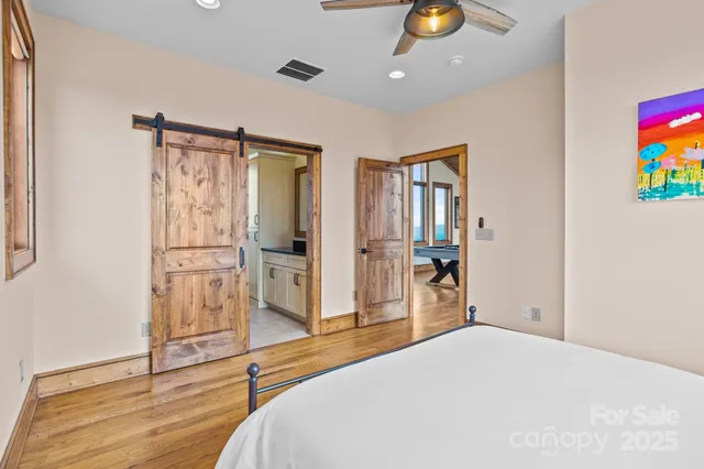 a bedroom with a bed and a large window