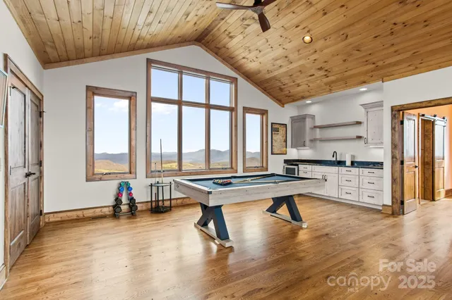 a bedroom with a large bed and a flat screen tv