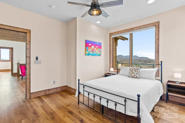 a bedroom with a large bed and a balcony view