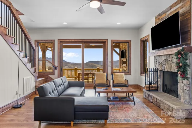 a dining room with stainless steel appliances granite countertop a refrigerator a stove a microwave oven with a dining table and chairs with wooden floor