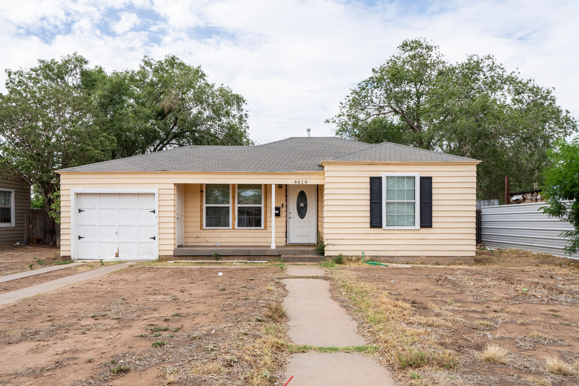 4614 33rd Street Lubbock, TX 79410 - Photo 2 of 3 a front view of a house with a yard