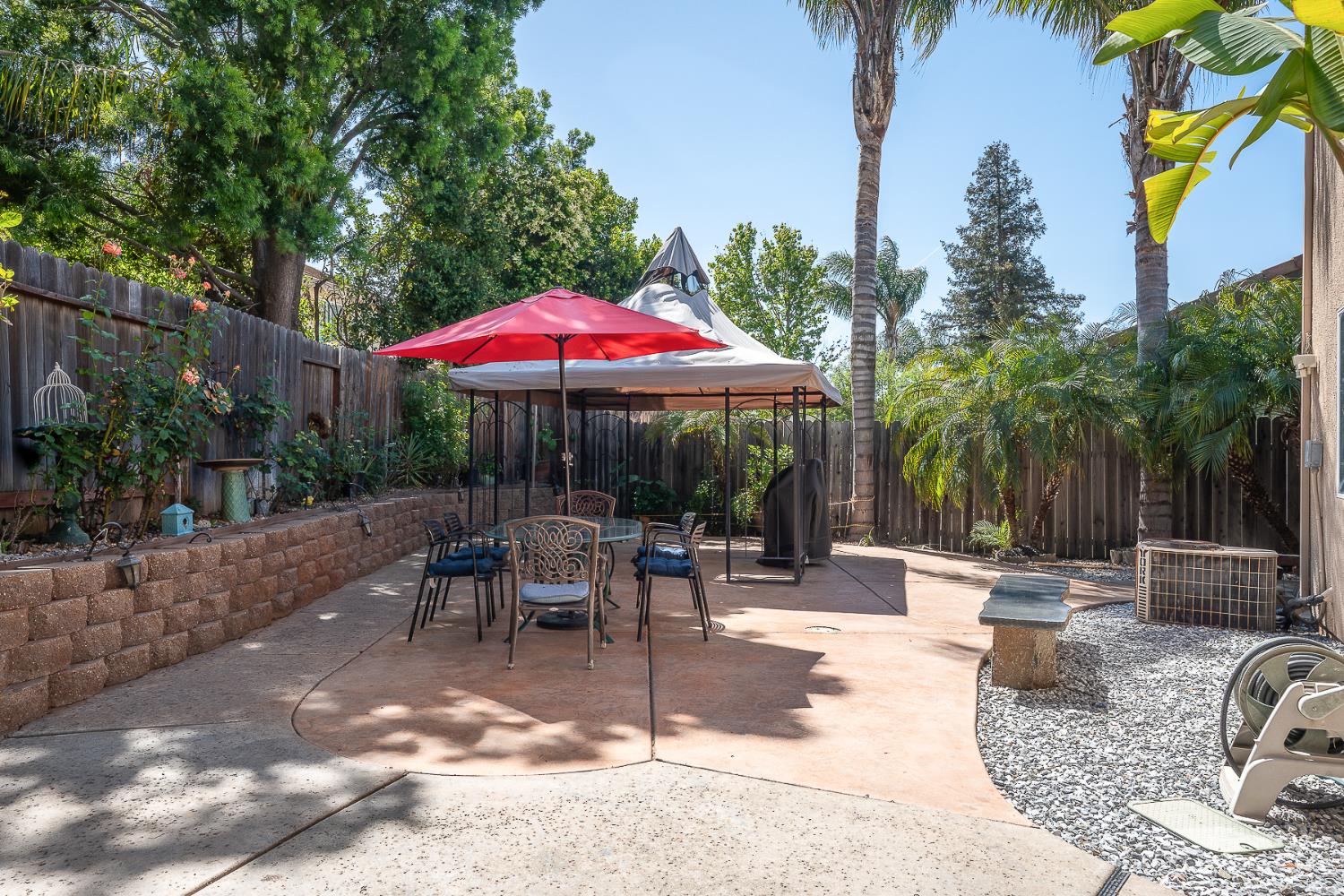 4237 Narraganset Way Mather, CA 95655 - Photo 34 of 40 a patio with a table and chairs under an umbrella