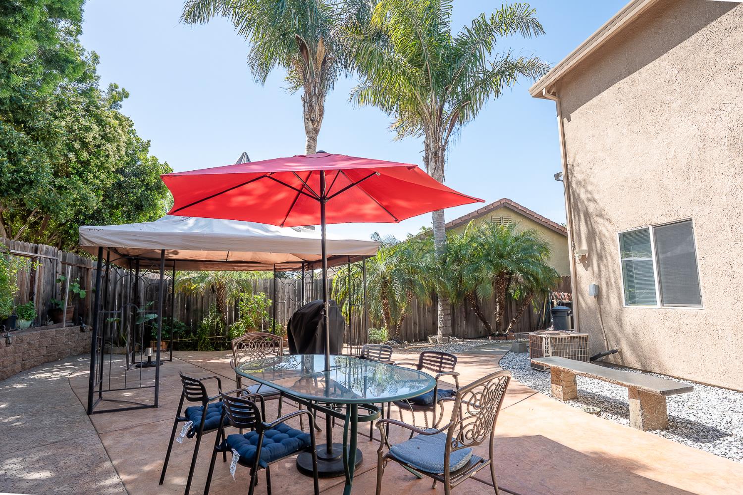 4237 Narraganset Way Mather, CA 95655 - Photo 35 of 40 a patio with a table and chairs under an umbrella